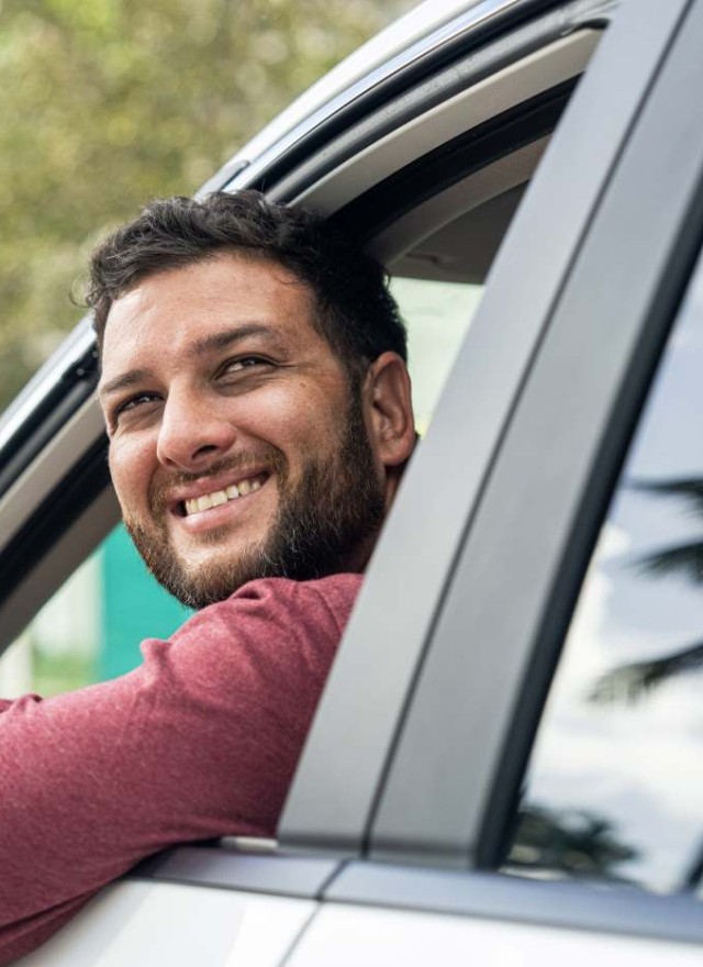 man smiling in car