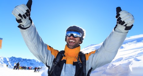 a skier giving two big thumbs up to the camera