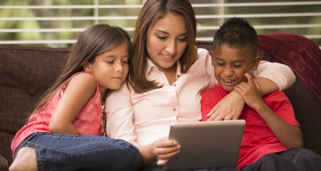 a mother reading with her two children