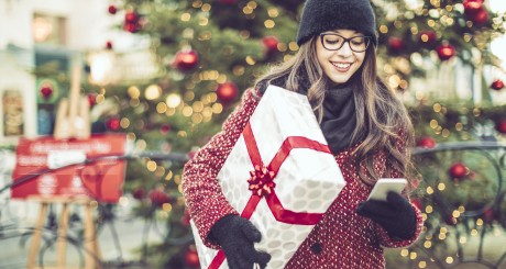 woman carrying christmas gifts