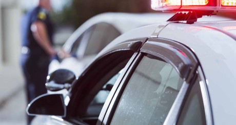 a police officer speaking to a driver after pulling them over