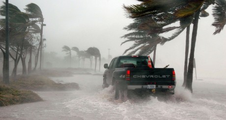 a truck driving near the beach while a hurricane is making landfall