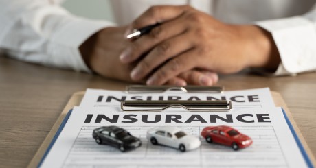 insurance paper with toy cars