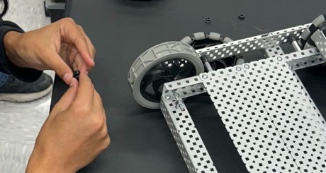 high school student working on robotic project