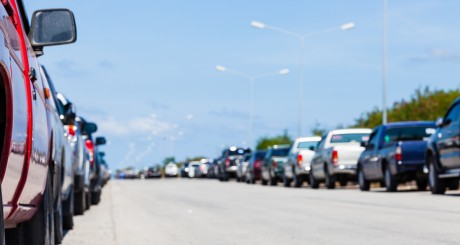 a parking lot with dozens of cars in it