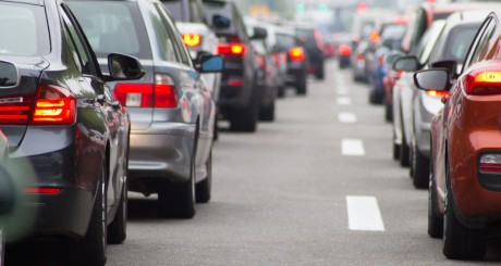 many cars lined up in bumper to bumper traffic