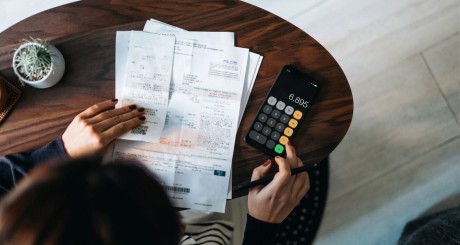 a woman balancing her budget after her car insurance went up