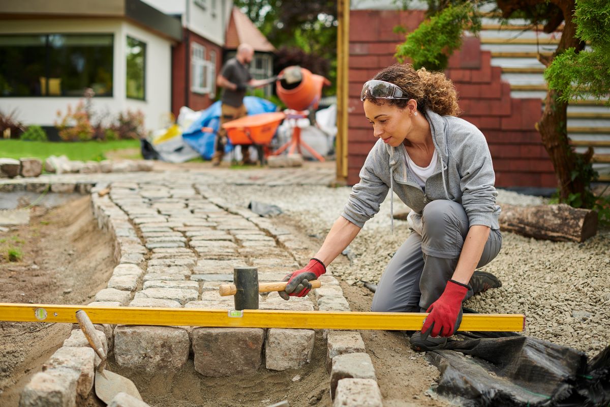 A Landscaper Levels a Sidewalk_0.jpg