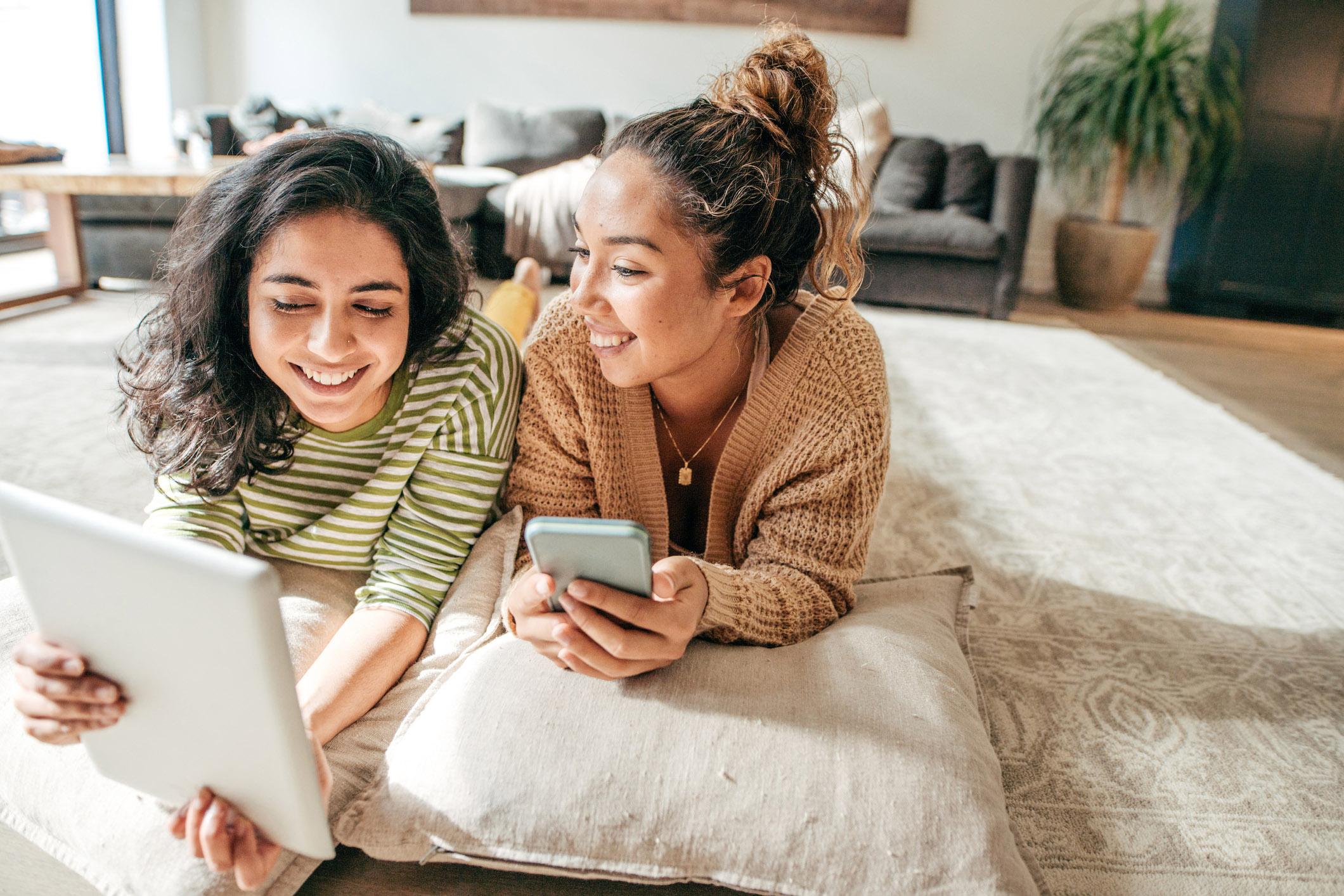 female-roommates-watching-tablet