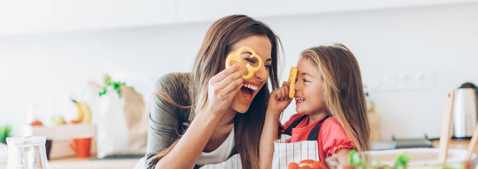 mother and daughter cooking vegetables