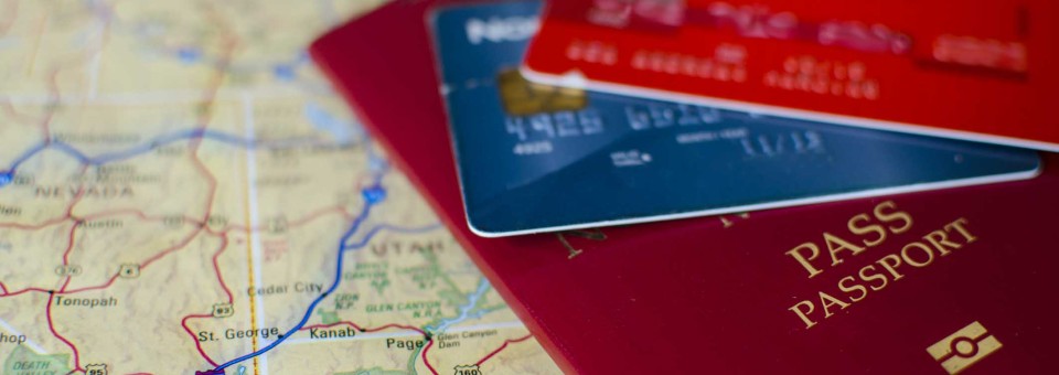 Credit Card and Passport Laying on Map credit-card-and-passport-on-map