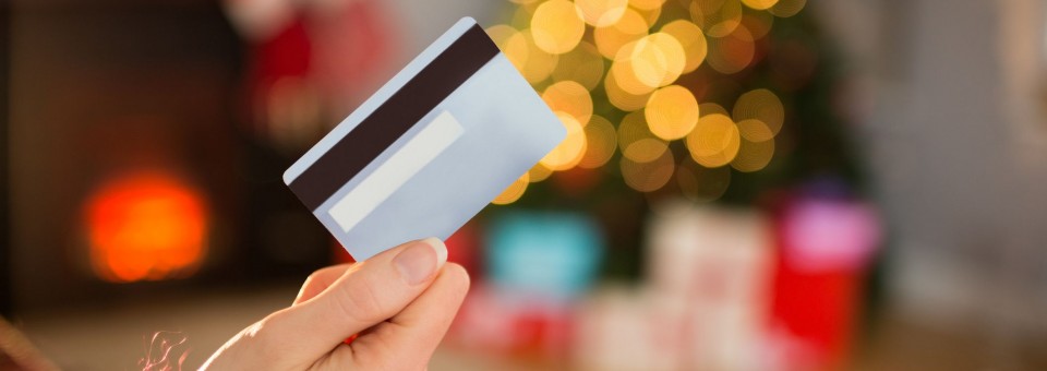 Woman Holding Credit Card during Holidays Woman Holding Credit Card during Holidays
