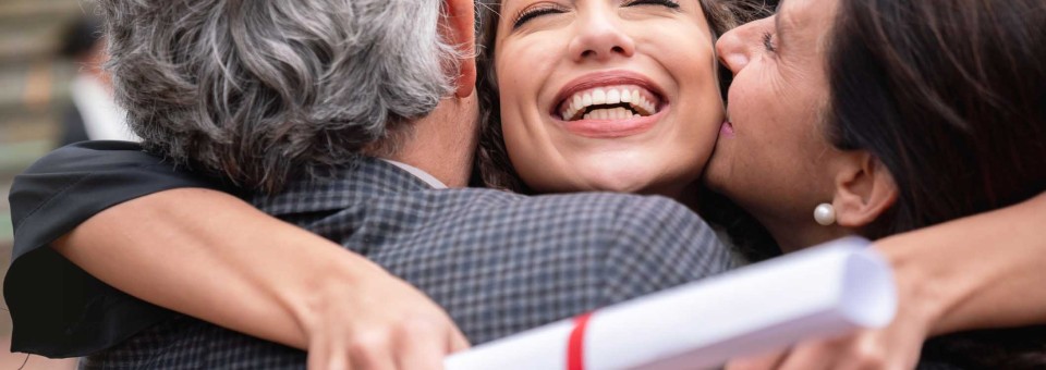 High School Grad Hugging Parents high-school-graduate