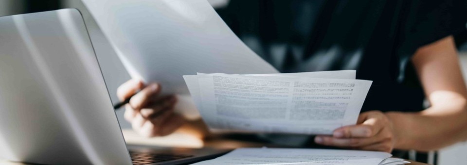 woman with several tax documents and other forms