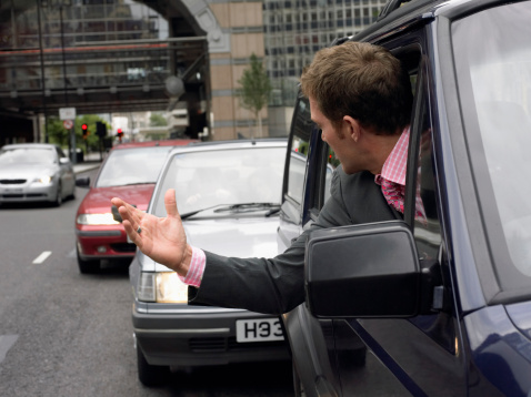 Angry man being tailgated while driving 